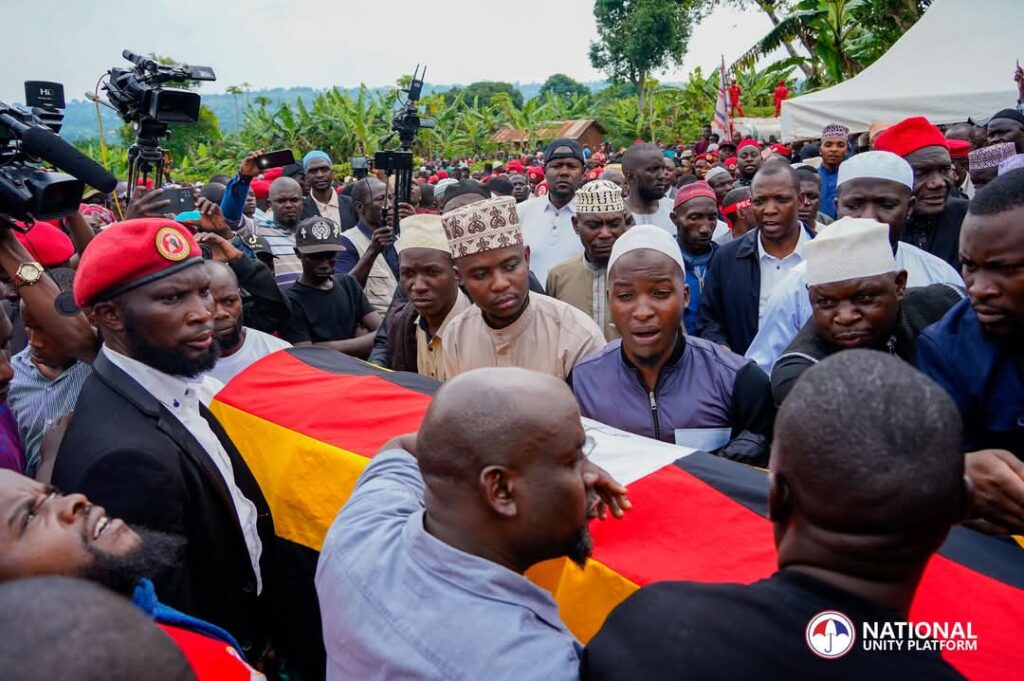 a group of people in a funeral procession, Muhammad Ssegirinya