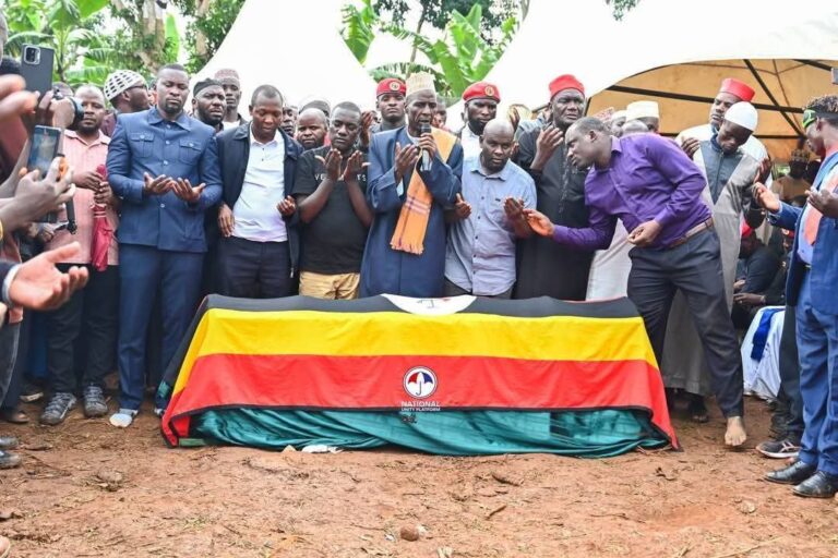 a group of people standing around a coffin, Muhammad Ssegirinya